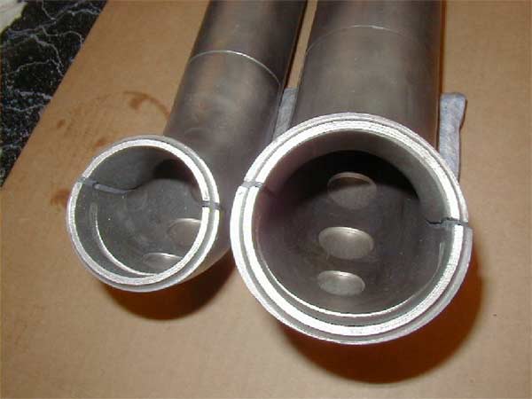 two pipes with multiple corrosion holes